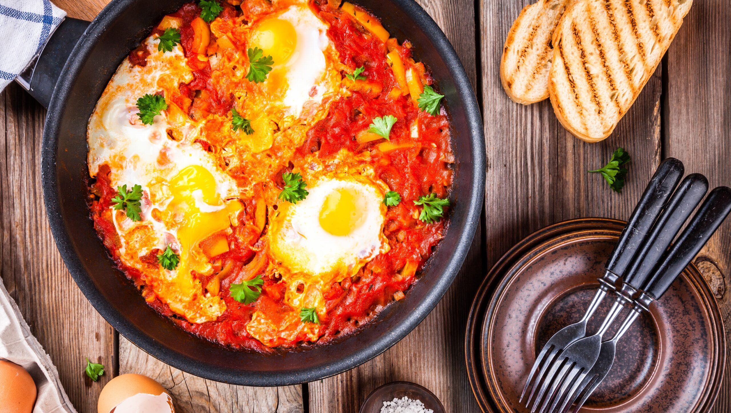 Shakshuka. Fried eggs with tomato,